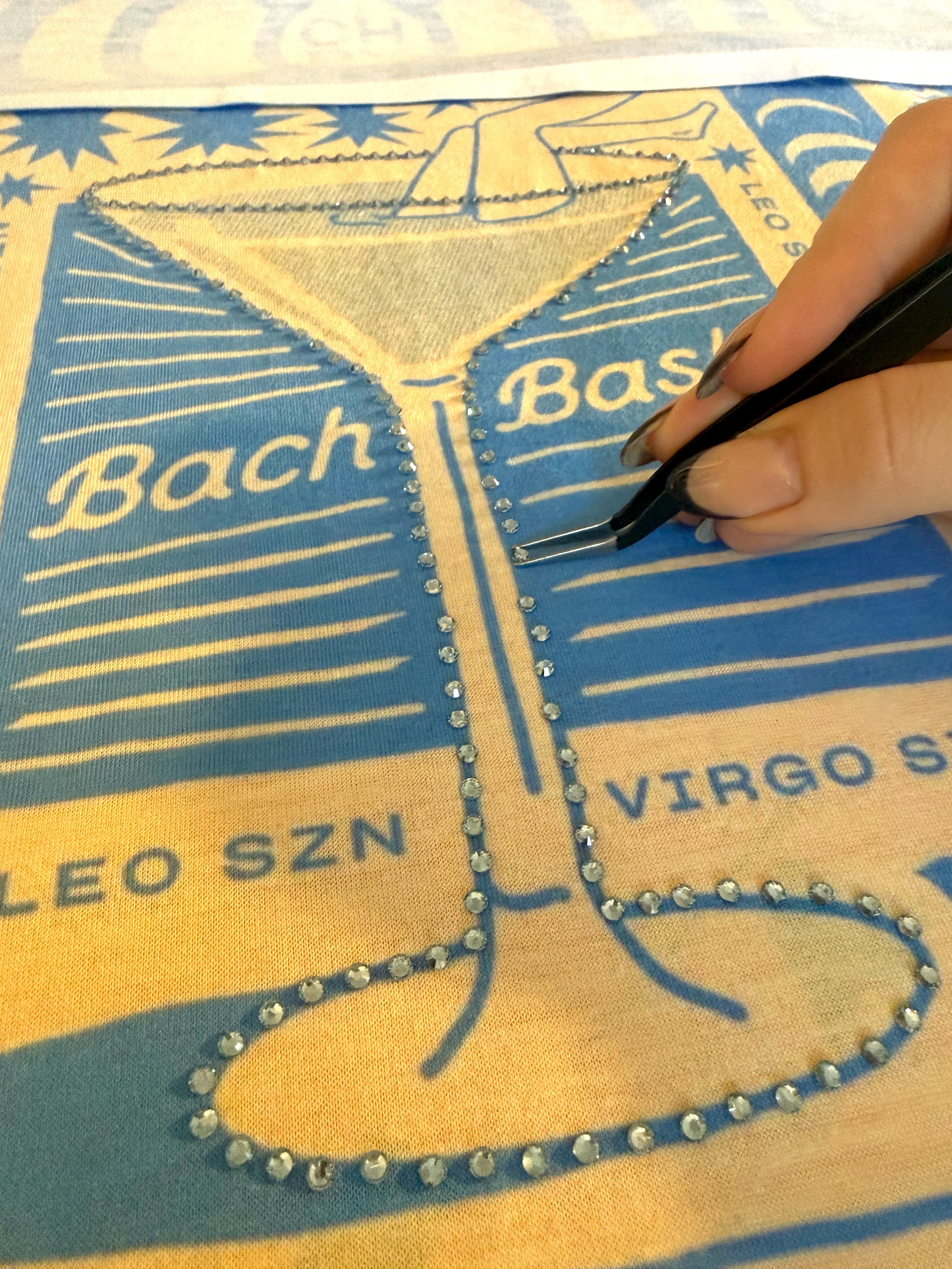 Adding jewels by hand to custom bandana design