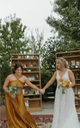 A bride and bridesmaid holding hands
